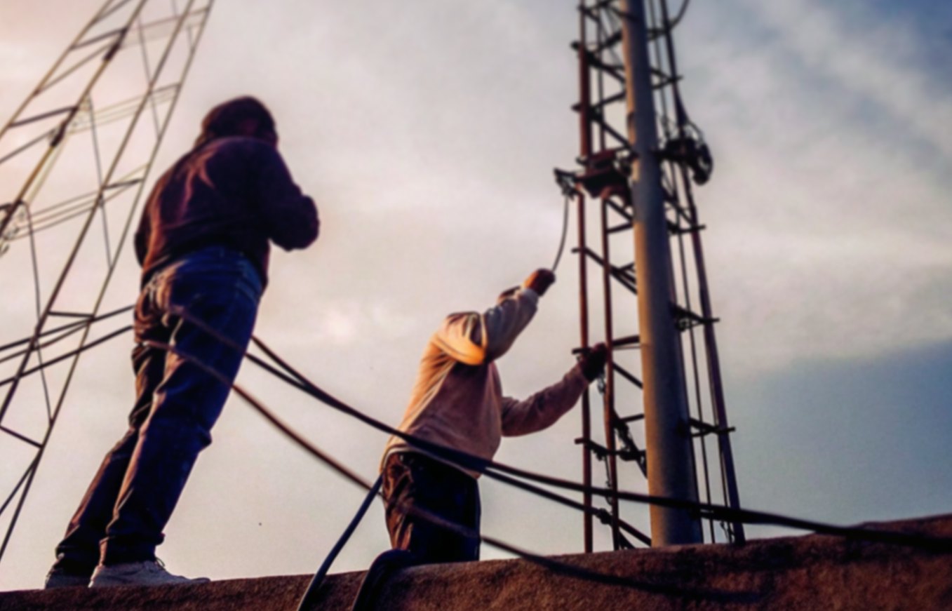Engineers working on a telecommunications tower